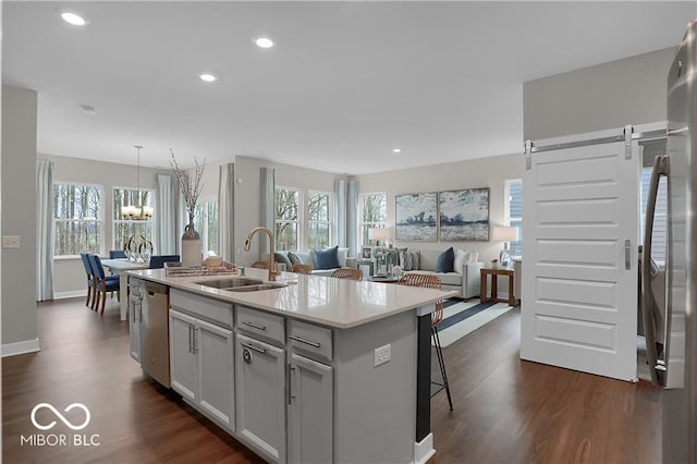19390 Mcbee Ave, Westfield, IN 46074 - kitchen with a sink, dishwasher, dark wood-style floors, an island with sink, and light countertops
