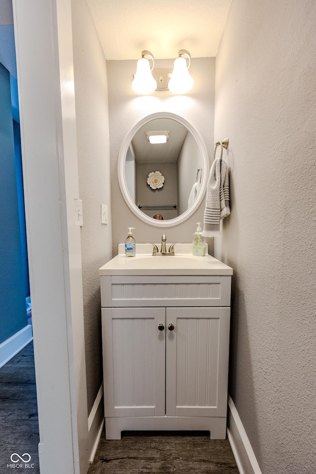 517 Bernard Ave, Indianapolis, IN 46208 - bathroom with vanity, wood finished floors, baseboards, and a textured wall