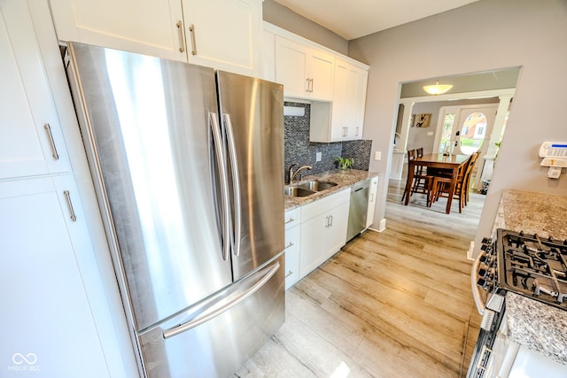 517 Bernard Ave, Indianapolis, IN 46208 - kitchen featuring stainless steel appliances, a sink, tasteful backsplash, white cabinets, and light stone counters