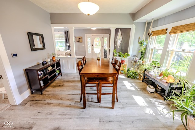 517 Bernard Ave, Indianapolis, IN 46208 - dining space featuring decorative columns, light wood-style floors, and baseboards