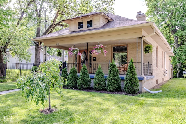 517 Bernard Ave, Indianapolis, IN 46208 - view of front of house featuring a chimney, covered porch, brick siding, and a shingled roof