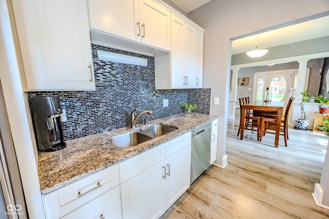517 Bernard Ave, Indianapolis, IN 46208 - kitchen featuring a sink, dishwasher, tasteful backsplash, light wood-style flooring, and white cabinetry