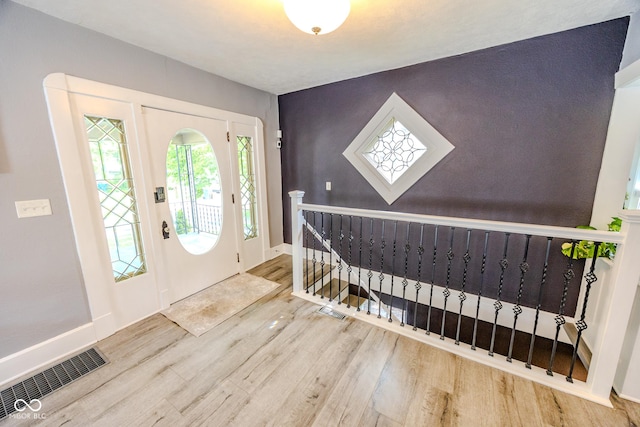 517 Bernard Ave, Indianapolis, IN 46208 - entryway with wood finished floors, an accent wall, and baseboards