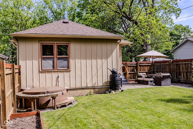 517 Bernard Ave, Indianapolis, IN 46208 - rear view of house featuring roof with shingles, a patio, and an outdoor hangout area