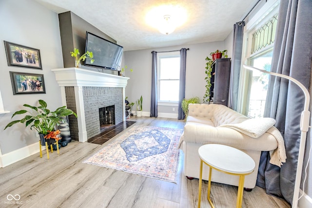 517 Bernard Ave, Indianapolis, IN 46208 - living area with a fireplace, wood finished floors, baseboards, and a textured ceiling