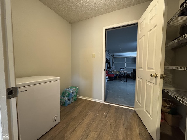 5502 Floating Leaf Dr, Indianapolis, IN 46237 - washroom featuring dark wood-type flooring, a textured ceiling, and baseboards