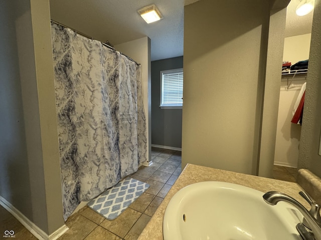 5502 Floating Leaf Dr, Indianapolis, IN 46237 - full bathroom featuring tile patterned floors, vanity, a shower with curtain, baseboards, and a spacious closet