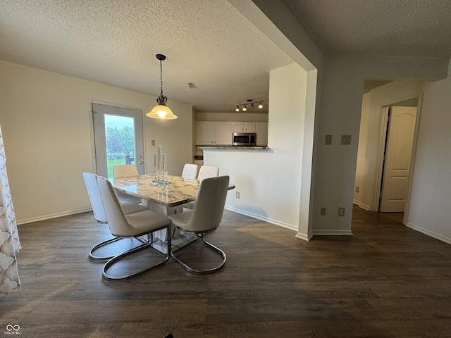 5502 Floating Leaf Dr, Indianapolis, IN 46237 - dining room with a textured ceiling, dark wood finished floors, rail lighting, and baseboards