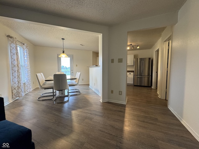 5502 Floating Leaf Dr, Indianapolis, IN 46237 - dining area featuring a textured ceiling, dark wood-style floors, and baseboards