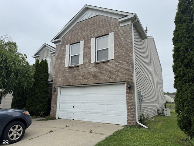 5502 Floating Leaf Dr, Indianapolis, IN 46237 - view of side of home featuring brick siding, a garage, concrete driveway, and a lawn