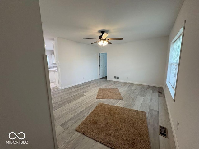 844 Ben Franklin St, Cloverdale, IN 46120 - empty room with a ceiling fan, light wood-type flooring, and baseboards