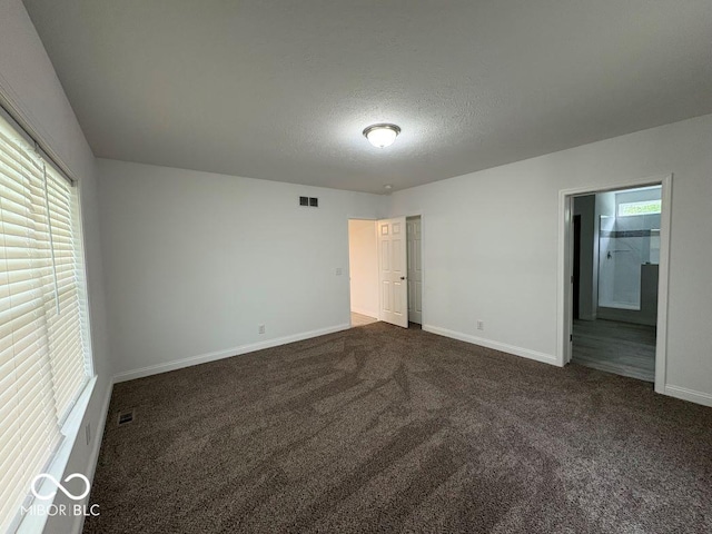 844 Ben Franklin St, Cloverdale, IN 46120 - unfurnished bedroom featuring dark carpet, baseboards, and a textured ceiling