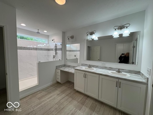 844 Ben Franklin St, Cloverdale, IN 46120 - bathroom featuring double vanity, a walk in shower, wood finished floors, and recessed lighting