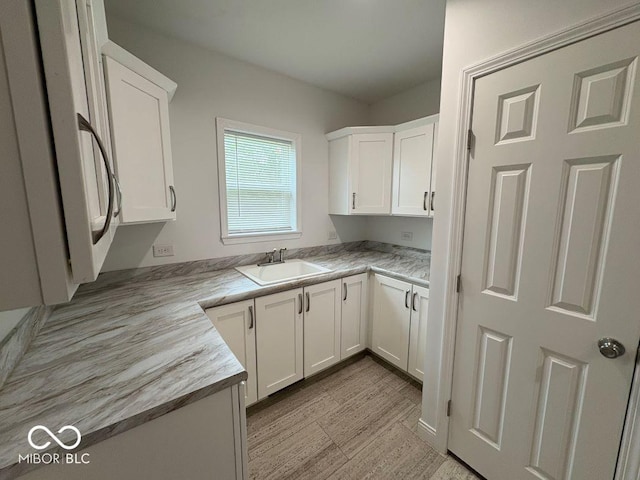 844 Ben Franklin St, Cloverdale, IN 46120 - kitchen with a sink, white cabinetry, and light countertops