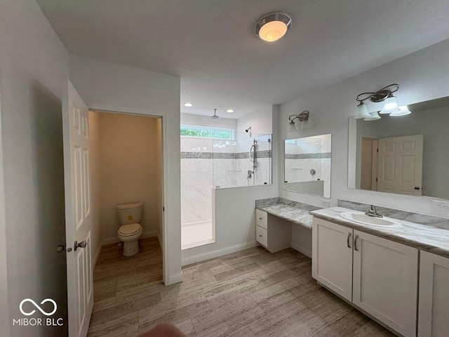 844 Ben Franklin St, Cloverdale, IN 46120 - bathroom featuring vanity, a walk in shower, toilet, wood finished floors, and baseboards