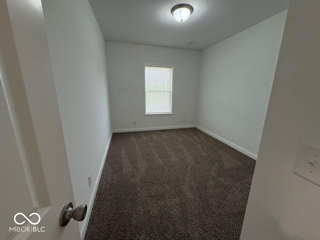 844 Ben Franklin St, Cloverdale, IN 46120 - empty room featuring dark colored carpet and baseboards