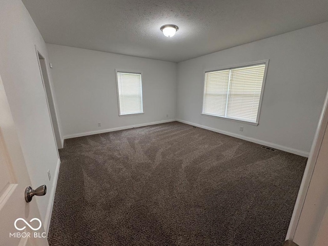 844 Ben Franklin St, Cloverdale, IN 46120 - spare room featuring dark carpet, baseboards, and a textured ceiling