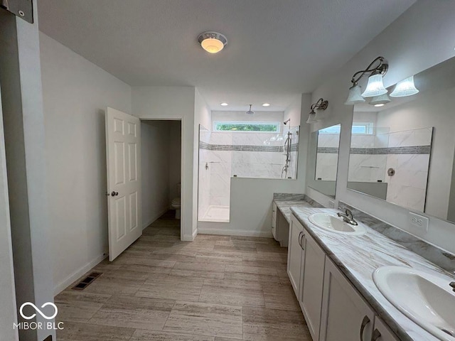 844 Ben Franklin St, Cloverdale, IN 46120 - full bathroom featuring a walk in shower, double vanity, toilet, and baseboards