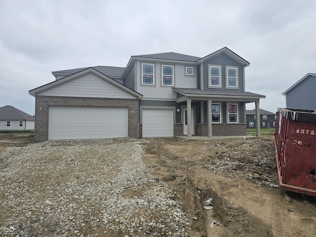 2287 Oakmont Dr, Plainfield, IN 46168 - view of front facade featuring brick siding, dirt driveway, and covered porch