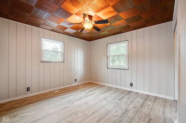 7482 W US Highway 40, Indianapolis, IN 46229 - empty room featuring healthy amount of natural light, light wood-style floors, wooden ceiling, a ceiling fan, and baseboards