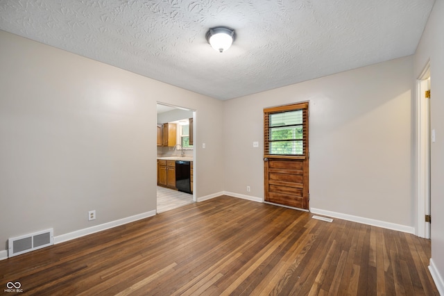 7482 W US Highway 40, Indianapolis, IN 46229 - unfurnished room with hardwood / wood-style flooring, a textured ceiling, baseboards, and a sink