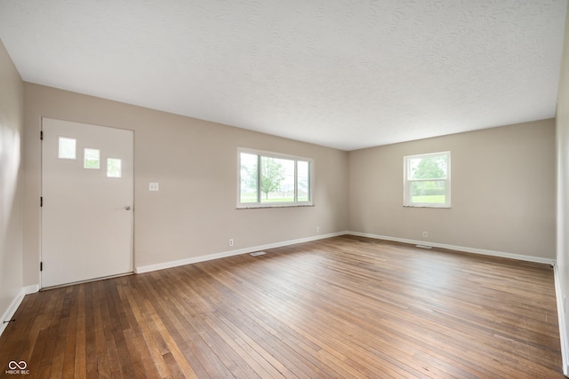 7482 W US Highway 40, Indianapolis, IN 46229 - entrance foyer featuring healthy amount of natural light, hardwood / wood-style flooring, baseboards, and a textured ceiling