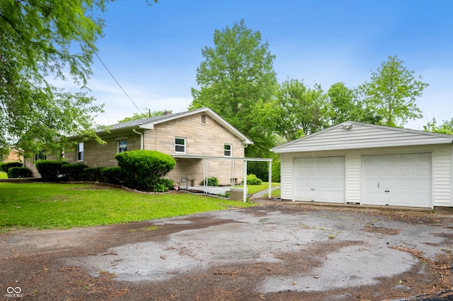 7482 W US Highway 40, Indianapolis, IN 46229 - view of side of home featuring a garage, an outbuilding, and a yard