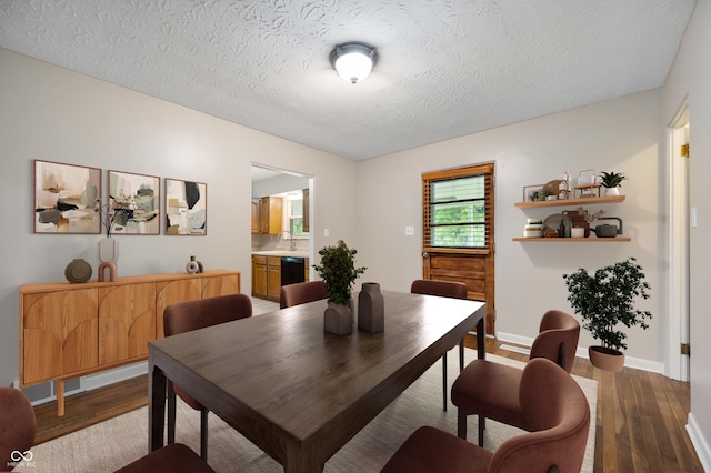 7482 W US Highway 40, Indianapolis, IN 46229 - dining space with wood finished floors, a textured ceiling, and baseboards