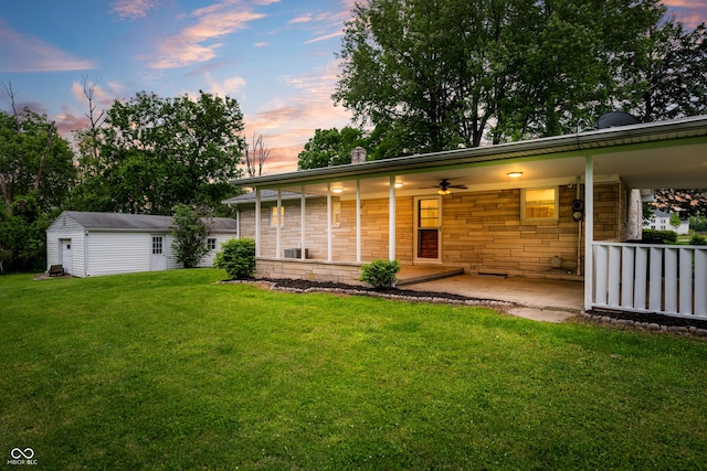 7482 W US Highway 40, Indianapolis, IN 46229 - view of front facade featuring a lawn, an outbuilding, ceiling fan, and a patio