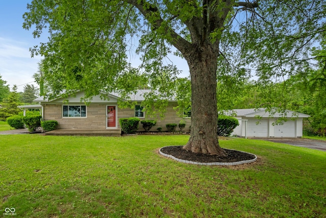 7482 W US Highway 40, Indianapolis, IN 46229 - ranch-style home with a front yard and a detached garage