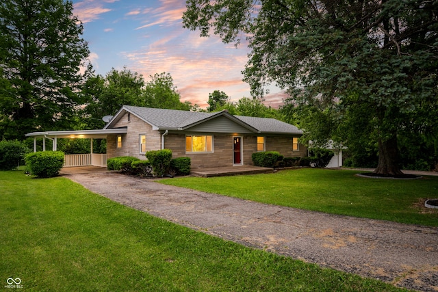 7482 W US Highway 40, Indianapolis, IN 46229 - view of front of property featuring driveway, a front yard, an attached carport, and roof with shingles