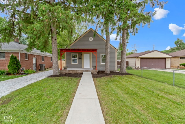 2046 N Tibbs Ave, Indianapolis, IN 46222 - view of front of home featuring covered porch and a detached garage