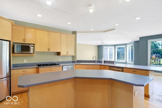 11575 Freeport Dr, Carmel, IN 46032 - kitchen with stainless steel appliances, light brown cabinetry, a sink, light wood-type flooring, and recessed lighting