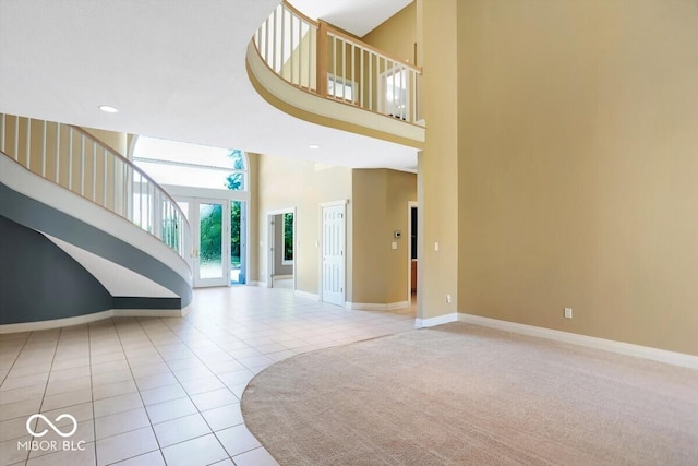 11575 Freeport Dr, Carmel, IN 46032 - unfurnished living room with a towering ceiling, tile patterned floors, baseboards, and recessed lighting