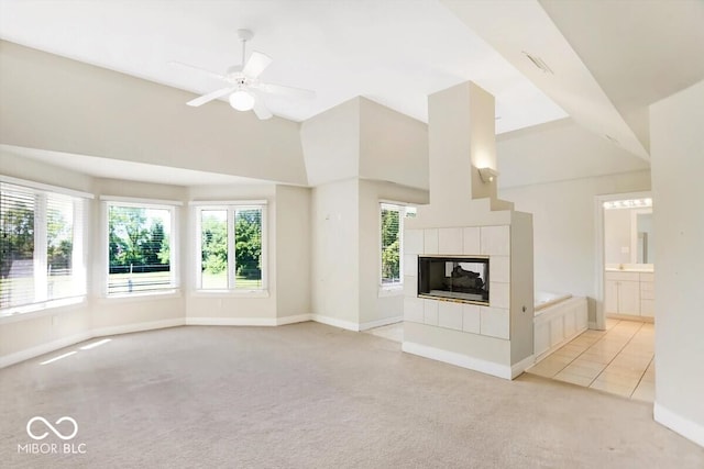 11575 Freeport Dr, Carmel, IN 46032 - unfurnished living room featuring light colored carpet, baseboards, a tile fireplace, healthy amount of natural light, and high vaulted ceiling
