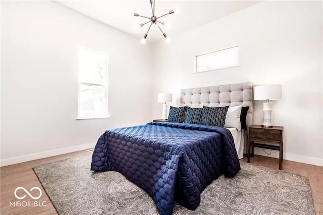 918 S State Ave, Indianapolis, IN 46203 - bedroom with baseboards, wood finished floors, and a chandelier