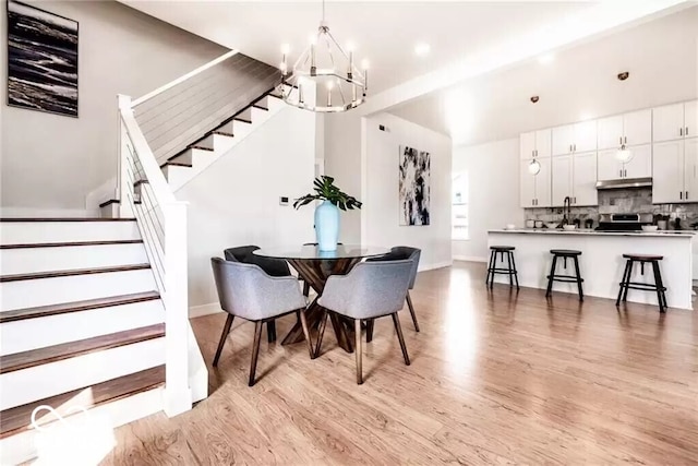 918 S State Ave, Indianapolis, IN 46203 - dining area featuring a chandelier, stairs, light wood-style floors, baseboards, and recessed lighting