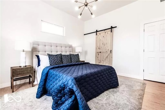 918 S State Ave, Indianapolis, IN 46203 - bedroom with baseboards, a barn door, wood finished floors, and a chandelier