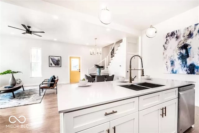 918 S State Ave, Indianapolis, IN 46203 - kitchen with a sink, stainless steel dishwasher, wood finished floors, white cabinetry, and light countertops