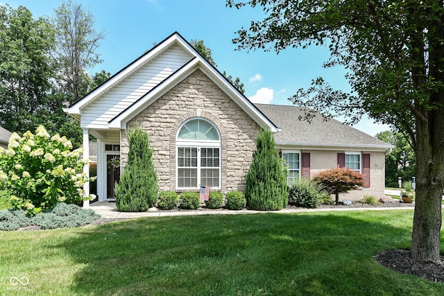 11692 Seven Oaks Dr, Fishers, IN 46038 - ranch-style home featuring stone siding, a front yard, roof with shingles, and brick siding
