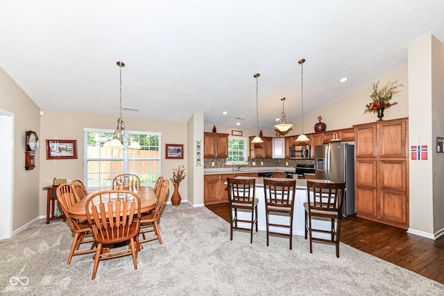 11692 Seven Oaks Dr, Fishers, IN 46038 - dining room featuring dark carpet, baseboards, a chandelier, lofted ceiling, and recessed lighting