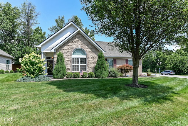 11692 Seven Oaks Dr, Fishers, IN 46038 - ranch-style house with stone siding and a front lawn