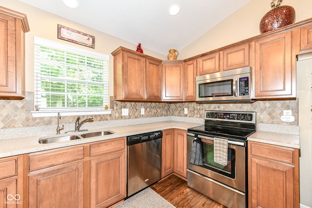 11692 Seven Oaks Dr, Fishers, IN 46038 - kitchen with appliances with stainless steel finishes, a sink, vaulted ceiling, light countertops, and dark wood-type flooring