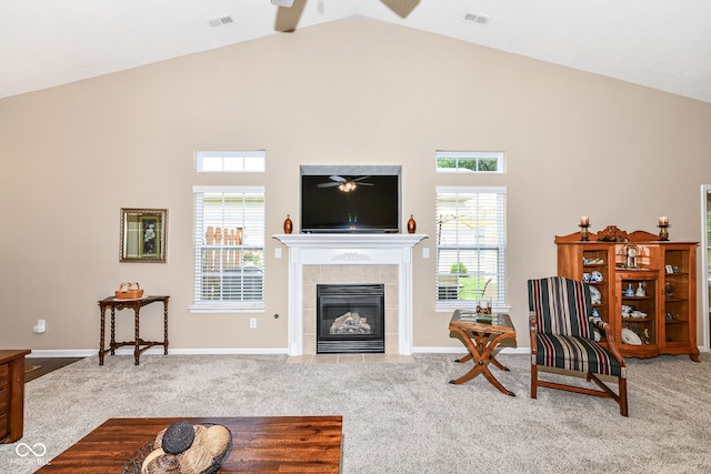 11692 Seven Oaks Dr, Fishers, IN 46038 - carpeted living area with a ceiling fan, high vaulted ceiling, a tile fireplace, and plenty of natural light