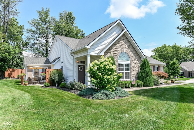 11692 Seven Oaks Dr, Fishers, IN 46038 - ranch-style home with stone siding, a patio, and roof with shingles