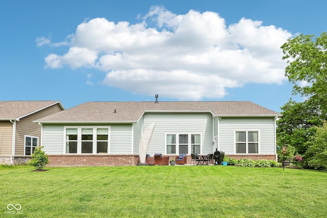 14458 Carlow Run, Carmel, IN 46074 - rear view of house with brick siding, a yard, and a shingled roof
