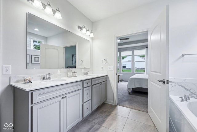 14458 Carlow Run, Carmel, IN 46074 - ensuite bathroom featuring double vanity, a garden tub, tile patterned flooring, and baseboards
