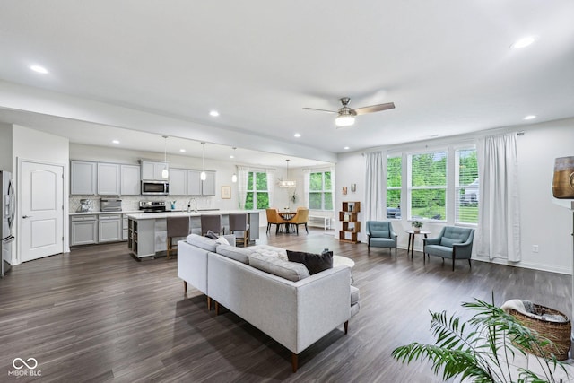 14458 Carlow Run, Carmel, IN 46074 - living room with dark wood-style flooring, plenty of natural light, a ceiling fan, and recessed lighting