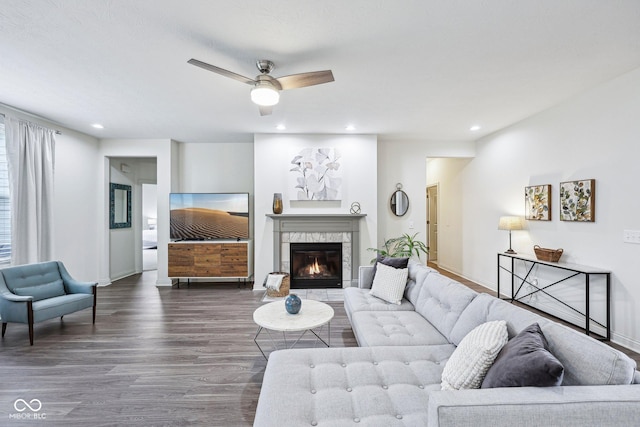 14458 Carlow Run, Carmel, IN 46074 - living area with dark wood finished floors, ceiling fan, a tiled fireplace, baseboards, and recessed lighting