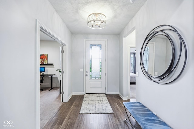 14458 Carlow Run, Carmel, IN 46074 - entrance foyer featuring a chandelier, dark wood-style flooring, and baseboards